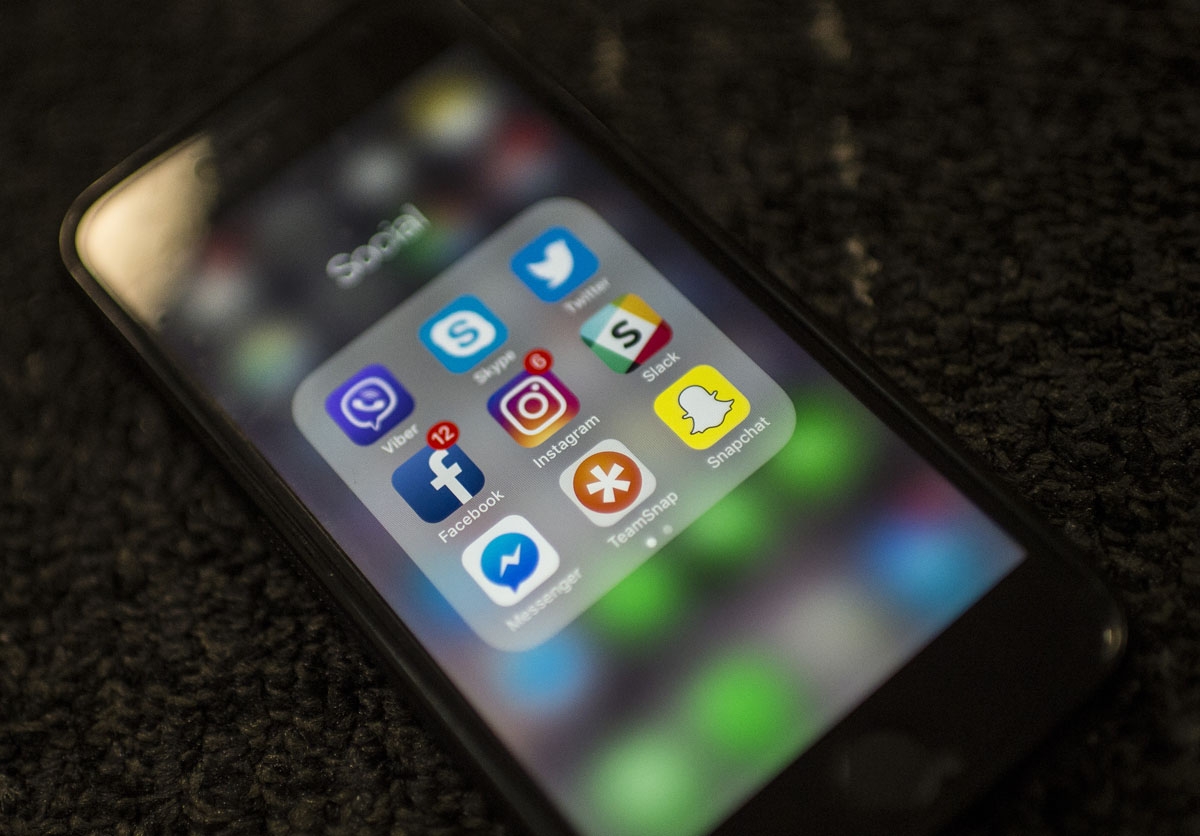 (FILES) In this file photo taken on March 21, 2018 Social Network applications including Facebook, Instagram, Slack, Snapchat, Twitter, Skype, Viber , Teamsnap and Messenger, are on display on a smartphone in Washington DC.