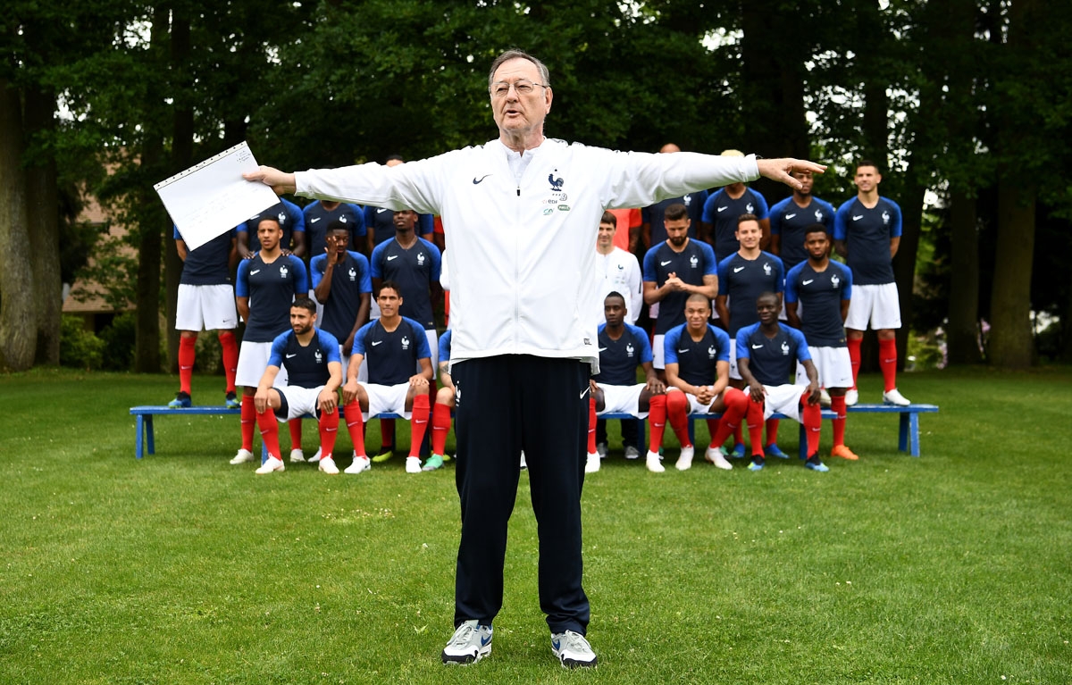 France's press officer Philippe Tournon manages photographers and cameramen before the official photo on May 30, 2018 in Clairefontaine-en-Yvelines ahead of the upcoming FIFA World Cup 2018 in Russia