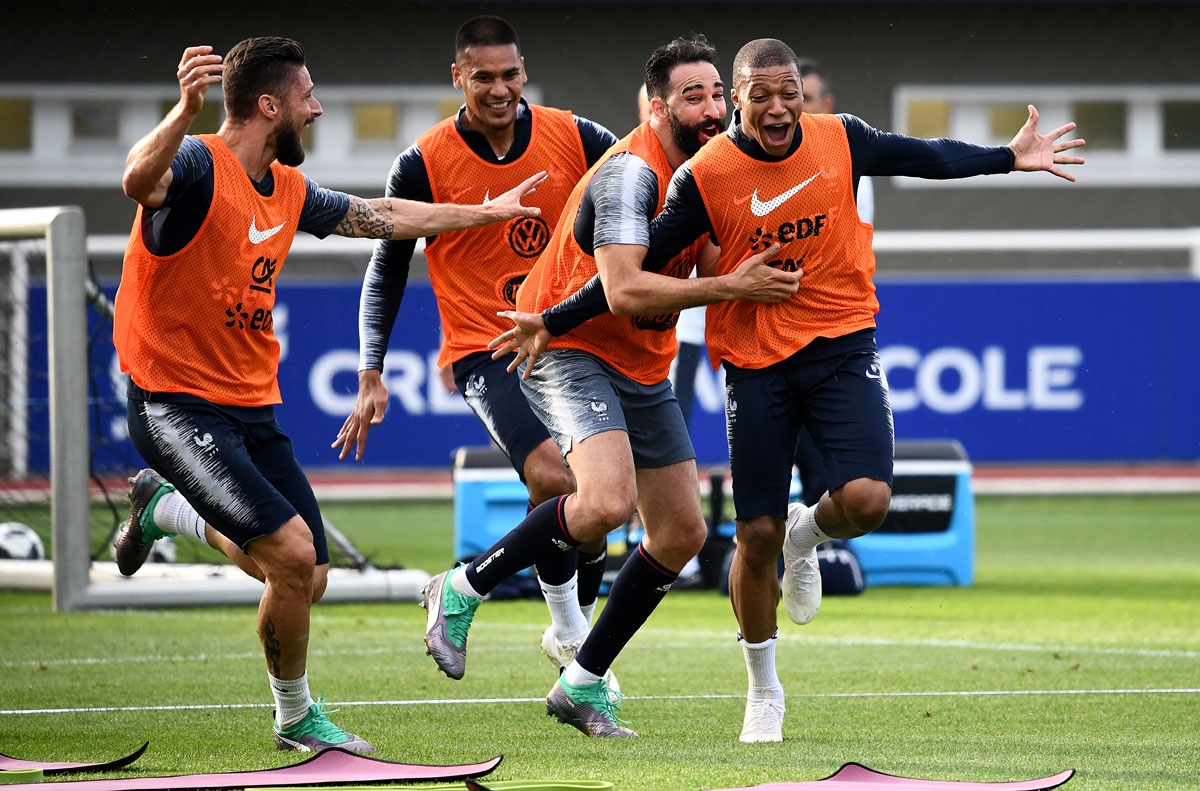 (From L) France's forward Olivier Giroud, France's goalkeeper Alphonse Aerola, France's defender Adil Rami and France's forward Kylian Mbappe react during a training session in Clairefontaine-en-Yvelines on June 4, 2018, as part of the team's preparation