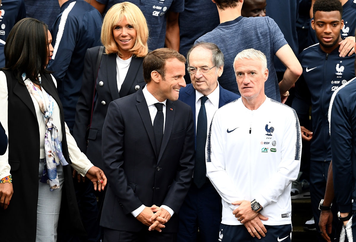 French Sports Minister Laura Flessel (L), French President Emmanuel Macron (C), his wife Brigitte Macron (2nd L), French football Federation (FFF) President Noel Le Graet (2nd R) and France's head coach Didier Deschamps (R) pose with France's players as t