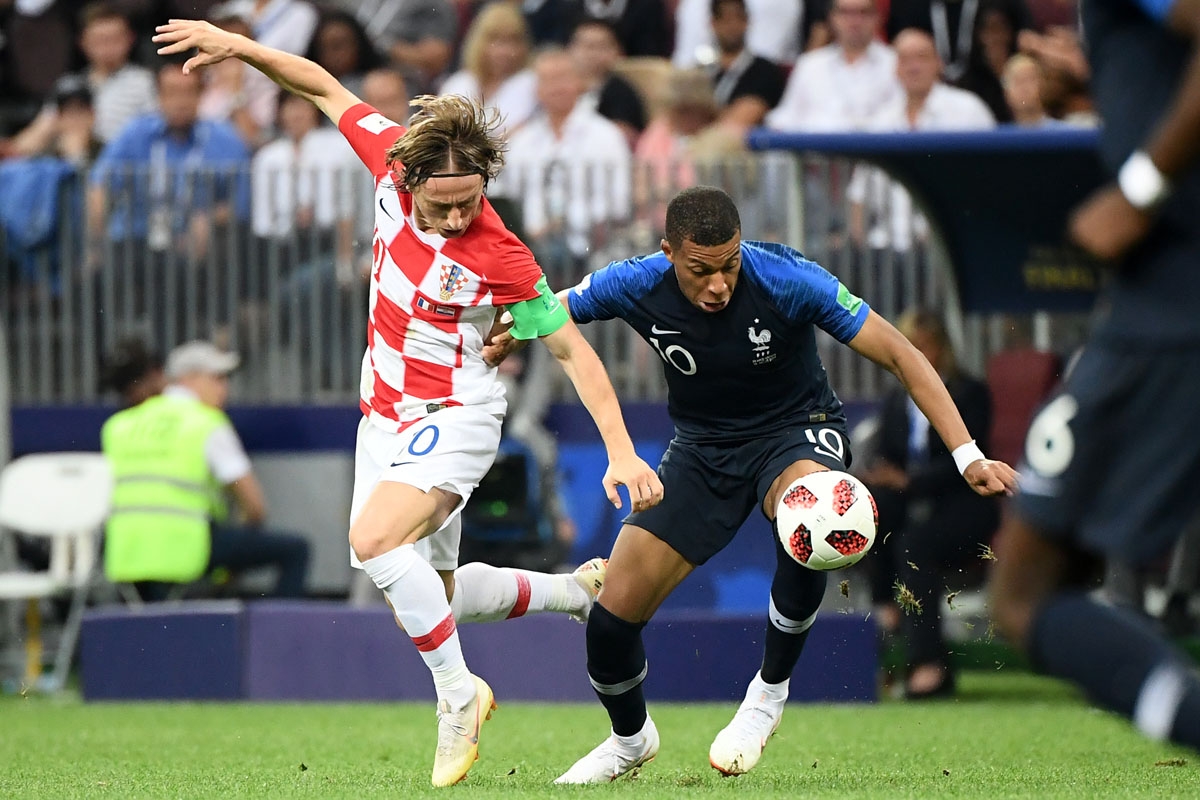 Croatia's midfielder Luka Modric (L) vies for the ball with France's forward Kylian Mbappe during their Russia 2018 World Cup final football match between France and Croatia at the Luzhniki Stadium in Moscow on July 15, 2018