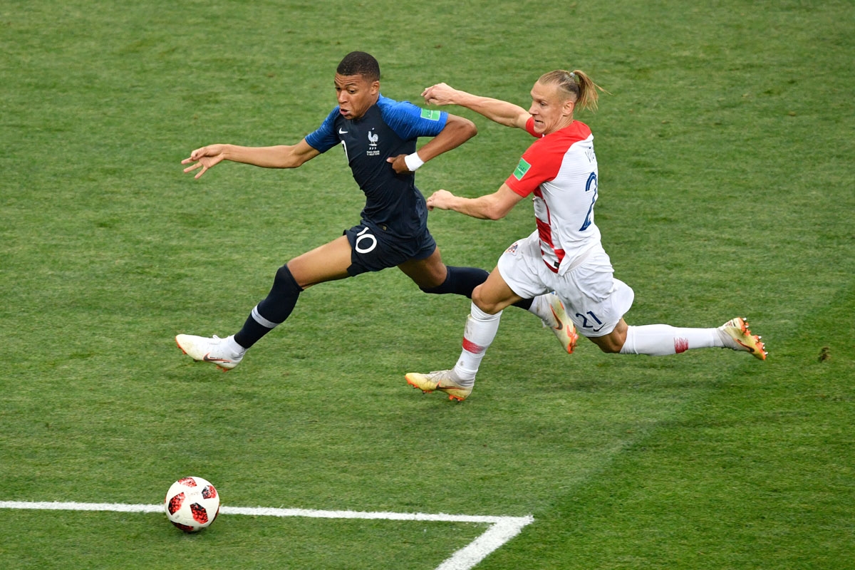 France's forward Kylian Mbappe (L) vies for the ball with Croatia's defender Domagoj Vida (R) during the Russia 2018 World Cup final football match between France and Croatia at the Luzhniki Stadium in Moscow on July 15, 2018