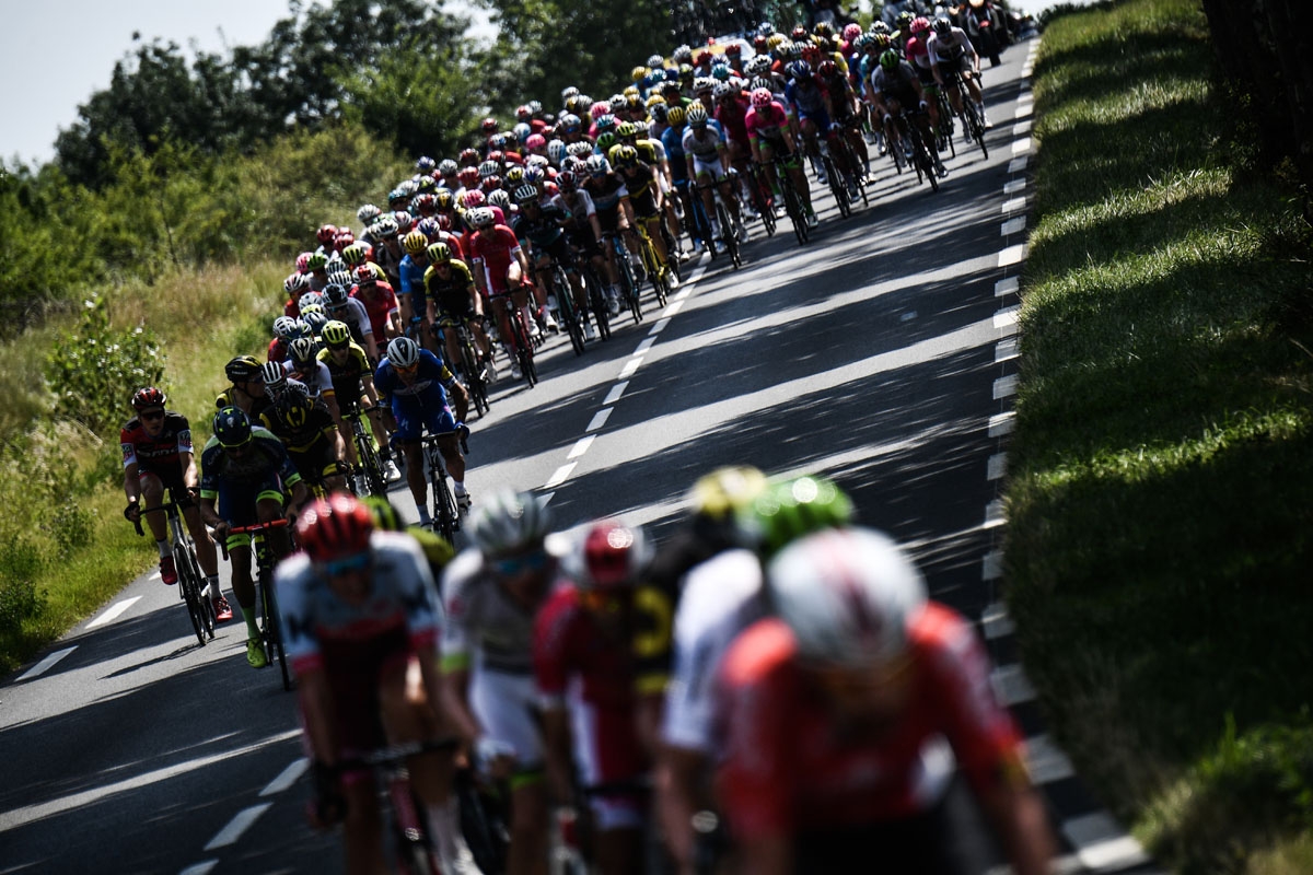 The pack rides during the 16th stage of the 105th edition of the Tour de France cycling race, between Carcassonne and Bagneres-de-Luchon, southwestern France, on July 24, 2018. / AFP PHOTO / Jeff PACHOUD