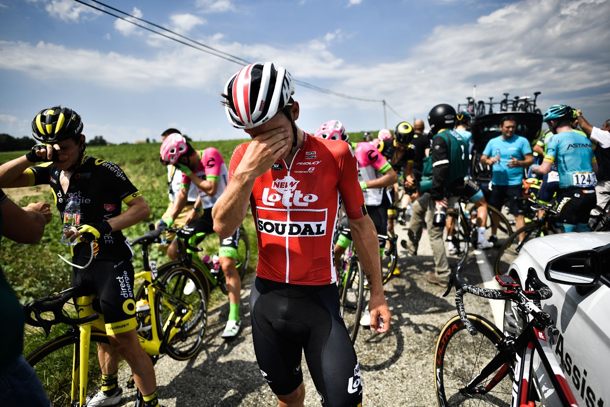 Riders clean their stinging eyes after tear gas was used during a farmers' protest who attempted to block the stage's route, during the 16th stage of the 105th edition of the Tour de France cycling race, between Carcassonne and Bagneres-de-Luchon, southwe