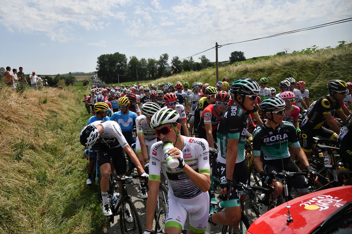 Riders of the pack wait for the race to resume, after the General Director of the Tour de France halted it, following a farmers' protest who attempted to block the stage's route, during the 16th stage of the 105th edition of the Tour de France cycling rac
