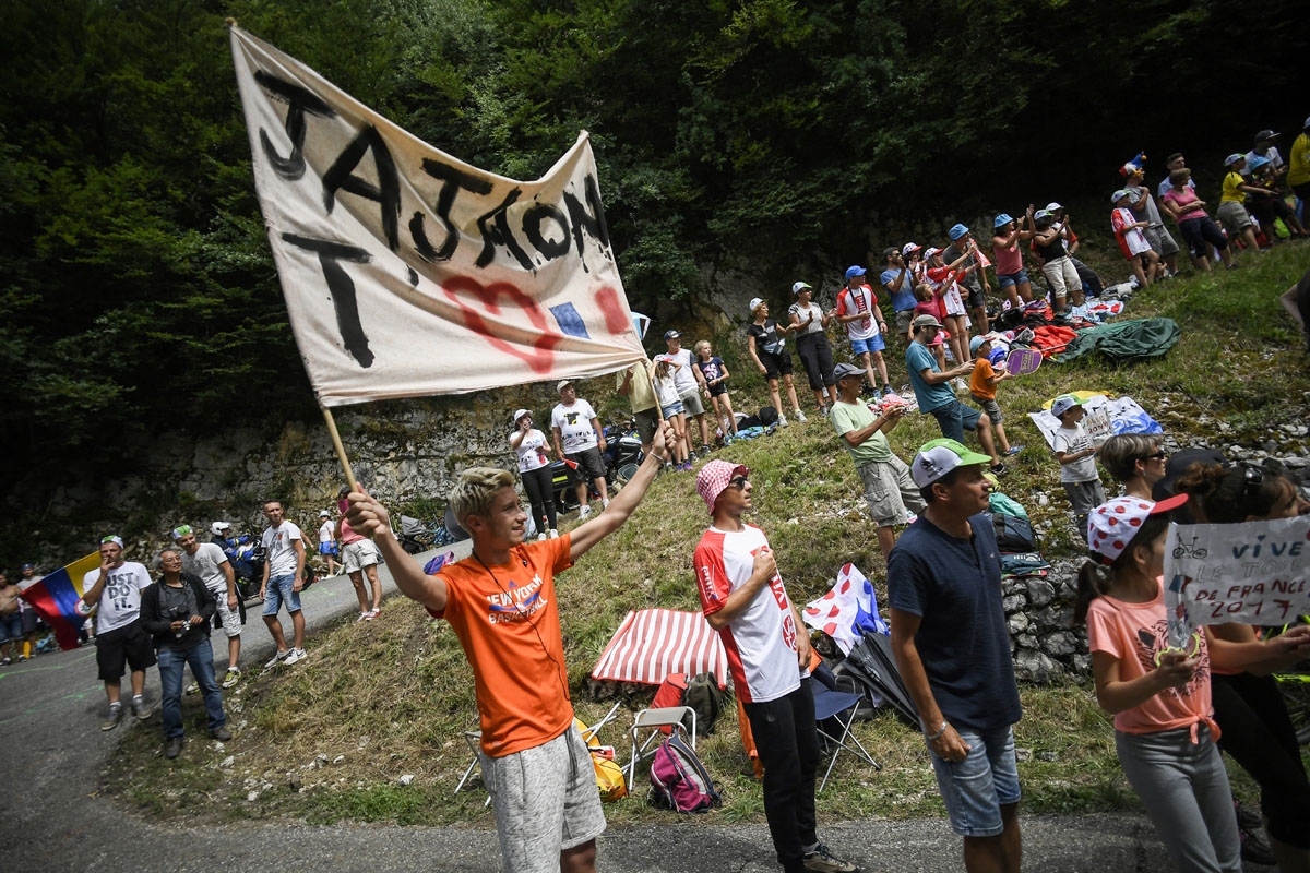 Supporters cheer along the road during the 181,5 km ninth stage of the 104th edition of the Tour de France cycling race on July 9, 2017 between Nantua and Chambery