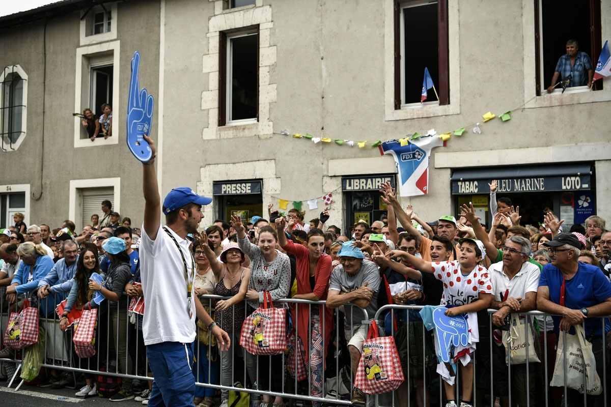 Supporters ask for goodies near the start line prior to the 203,5km eleventh stage of the 104th edition of the Tour de France cycling race on July 12, 2017 between Eymet and Pau.