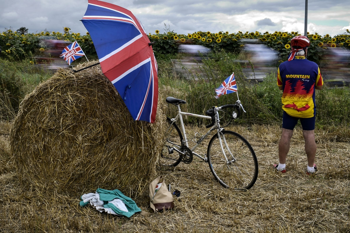 A british supporter cheers along the road next to UK Union Jack flags during the 203,5km eleventh stage of the 104th edition of the Tour de France cycling race on July 12, 2017 between Eymet and Pau. /