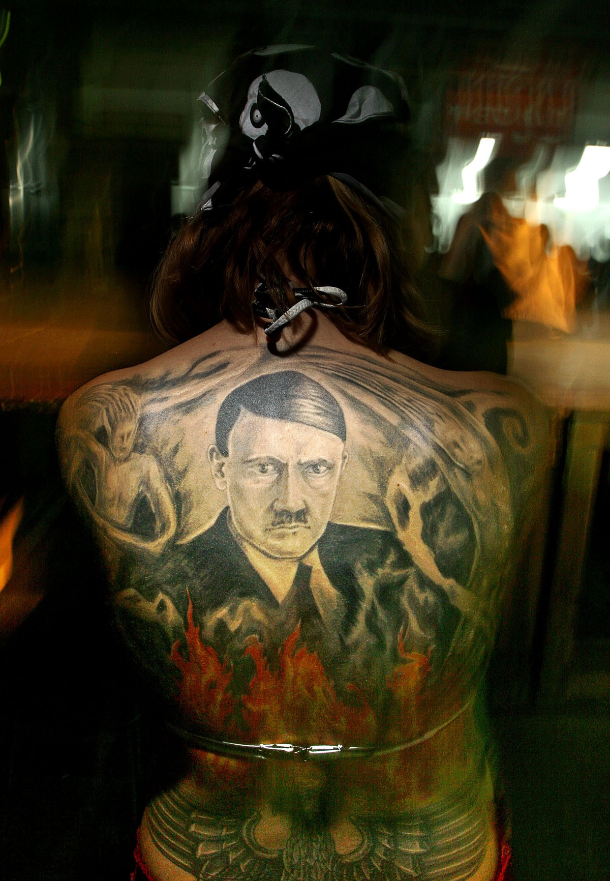 A Bulgarian girl shows off her tattoo representing Adolf Hitler as she takes part in a contest during the annual Tattoo and Piercing festival in Sofia, 08 October 2005.