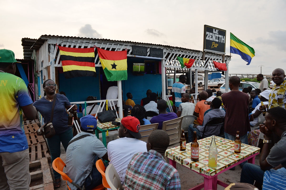 People watch the opening game of the 2017 Africa Cup of Nations football tournament between Gabon and Guinea-Bissau at a bar in Port-Gentil on January 14, 2017.