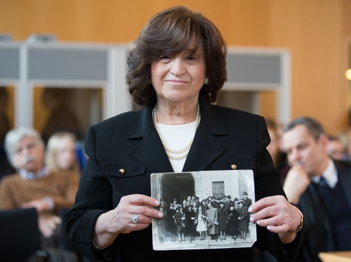 Witness Angela Orosz who was born in Auschwitz shows a photo of her parents wedding guests, while attending the trial of former Nazi death camp SS guard Reinhold Hanning in Detmold, Germany, on February 26, 2016.