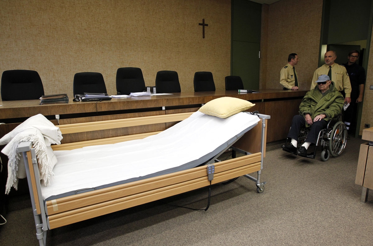 John Demjanjuk, accused of being a guard at a Nazi death camp Sobibor, arrives in a wheelchair for another day of his trial in the courtroom in Munich on March 17, 2011