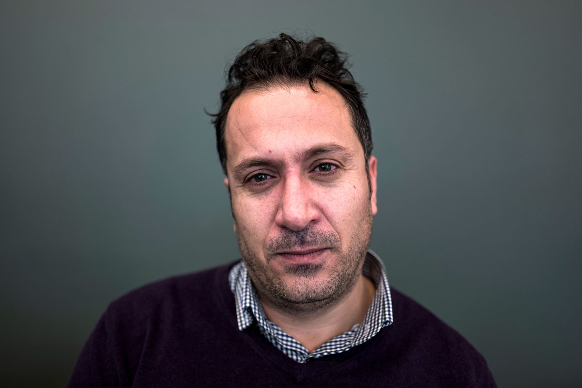Syrian refugee Shappal Ibrahim, who says he was detained for one and a half years at the Saydnaya military prison, poses on November 8, 2017 in Berlin after taking part in a press conference ?organised by two human rights pressure groups calling on the Ge