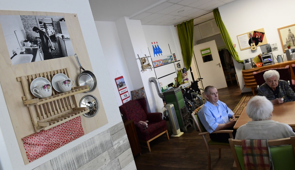 Residents sit together at a table inside an east German 60s lounge at a nursing home in Dresden, eastern Germany, on June 14, 2017.