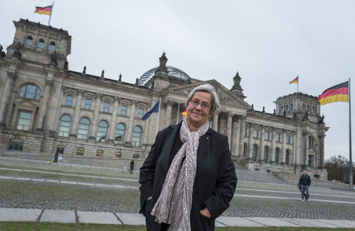 Karin Felix, who served as a guide at the Reichstag parliament building for a quarter-century, poses in front the Reichstag builing in Berlin on November 23, 2017.