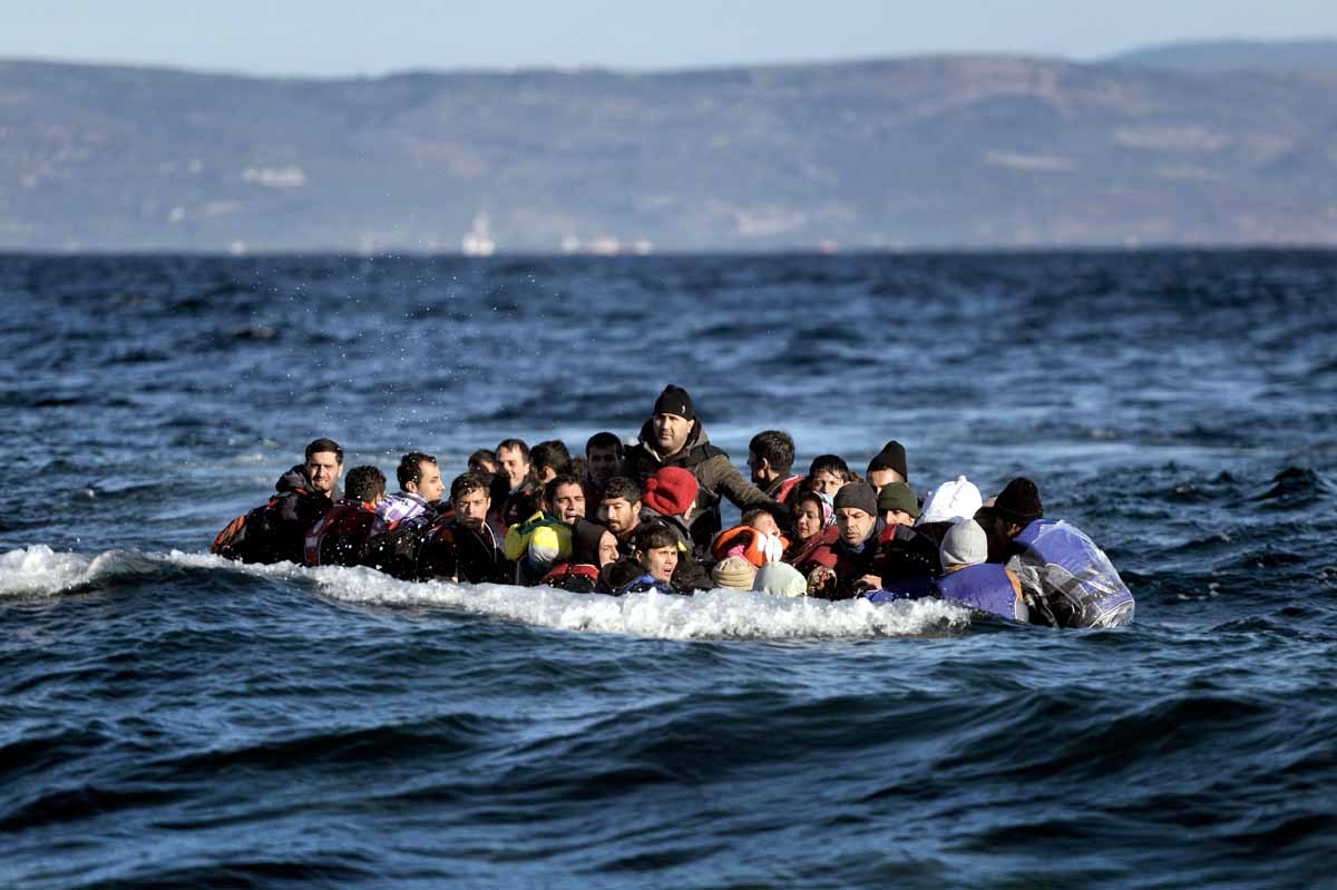 Refugees and migrants arrive on the Greek Lesbos island after crossing the Aegean Sea from Turkey on November 2, 2015.
