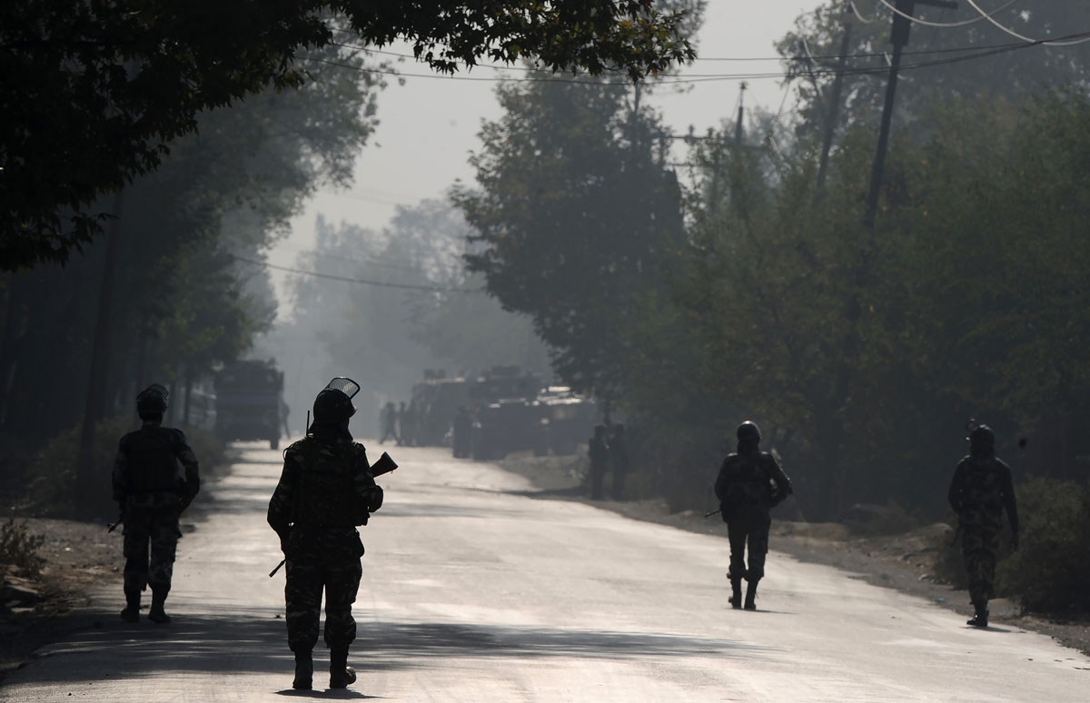 Indian paramilitary troopers patrol on the third day, near the site of a gunfight between the Indian army and suspected militants in Pampore, south of Srinagar on October 12, 2016