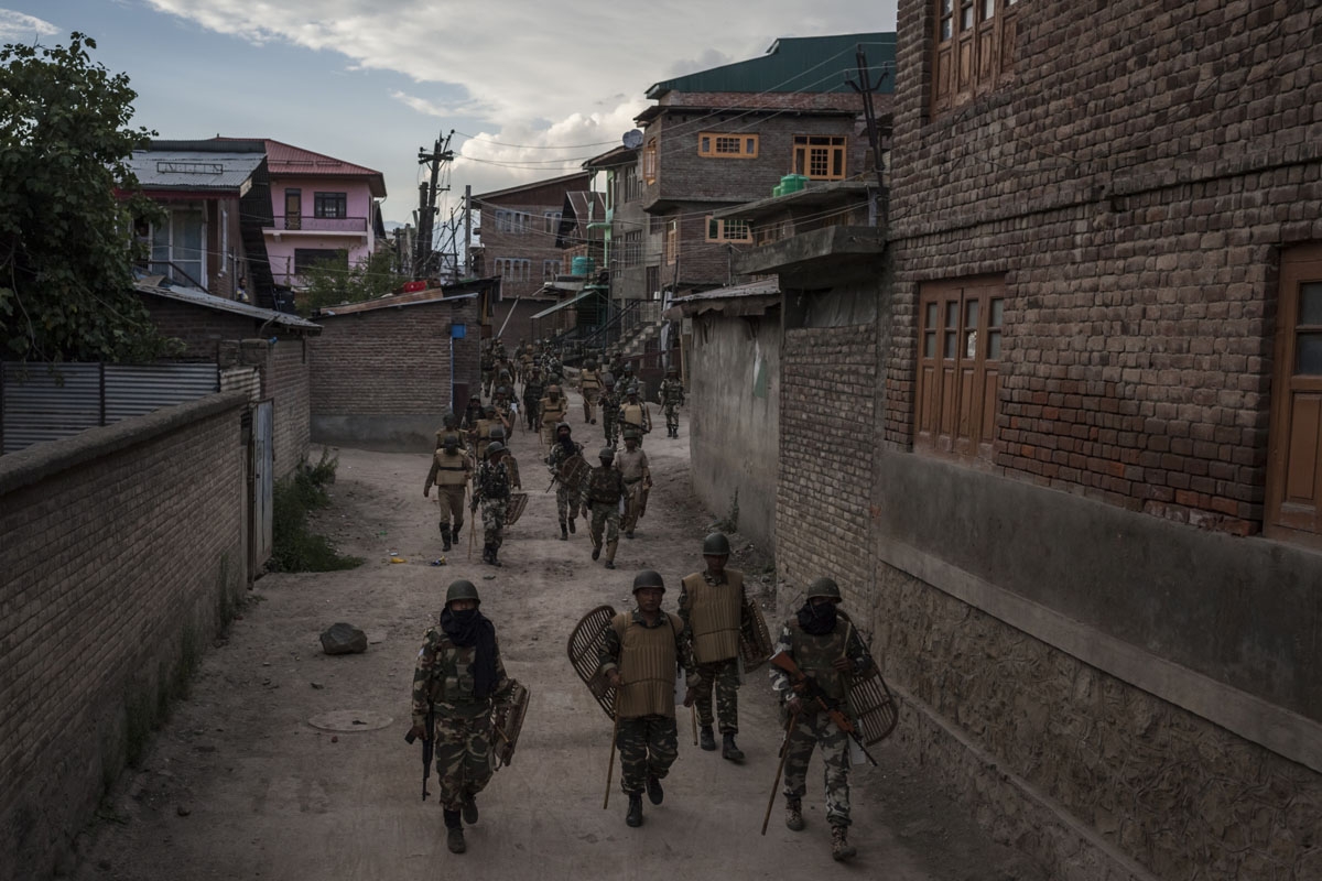 In this photo taken on August 18, 2016, Indian Central Reserve Police Force (CRPF) and security personnel retreat following a day of curfew and shutdown in downtown Srinagar.