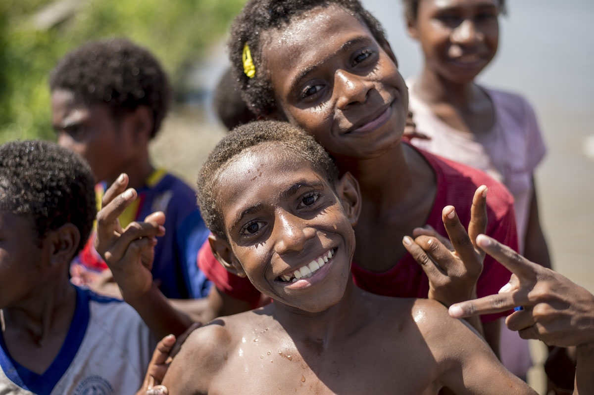Papuan children pose in Agats, the capital of Asmat district in Indonesia's easternmost Papua province, on January 25, 2018.