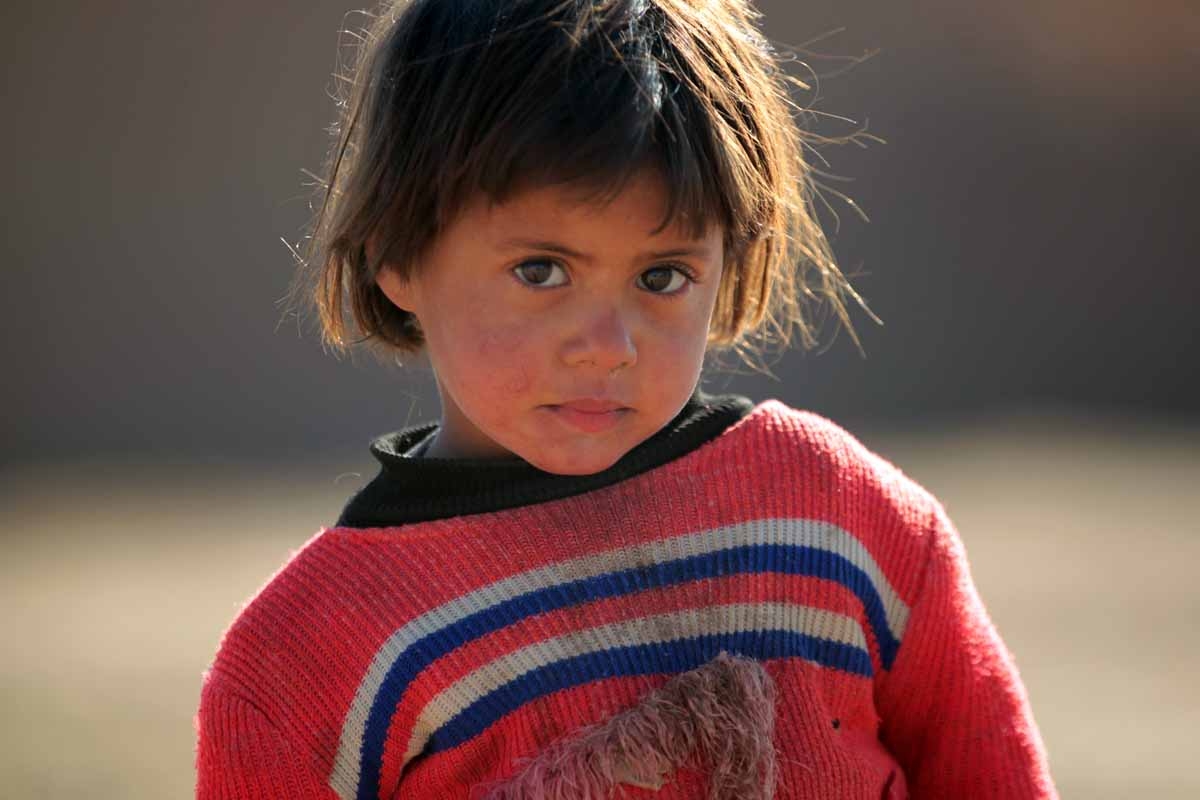 A displaced Iraqi child, from the outskirts of the city of Tal Afar, poses at a makeshift camp on December 12, 2016 in the village of Khalif Saleh, south of Tal Afar, where his families found refuge as Iraqi forces continue their assault to eject Islamic