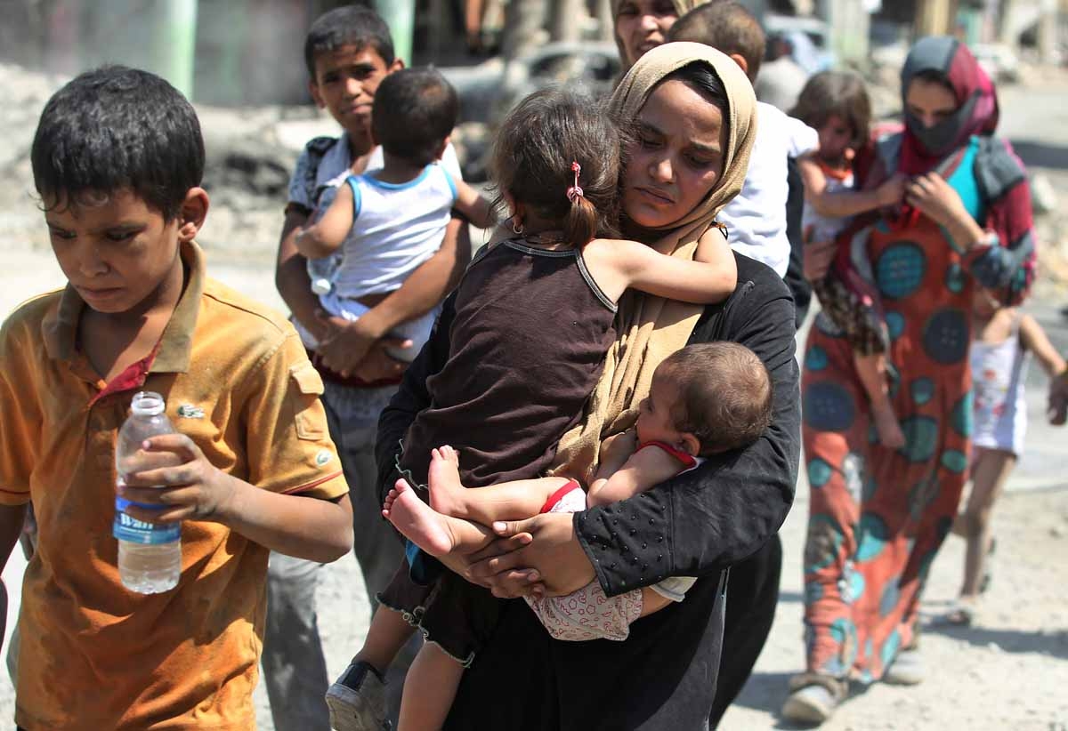 Iraqis flee from the Old City of Mosul on July 5, 2017, during the Iraqi government forces' offensive to retake the city from Islamic State (IS) group fighters.