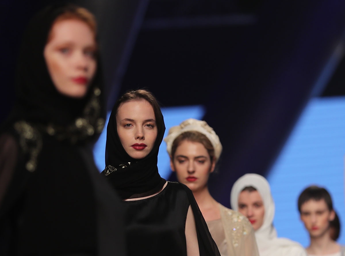 Models walk down the catwalk wearing designs by Zoe Eckett during the Arab Fashion Week in the United Arab Emirate of Dubai on May 18, 2017.