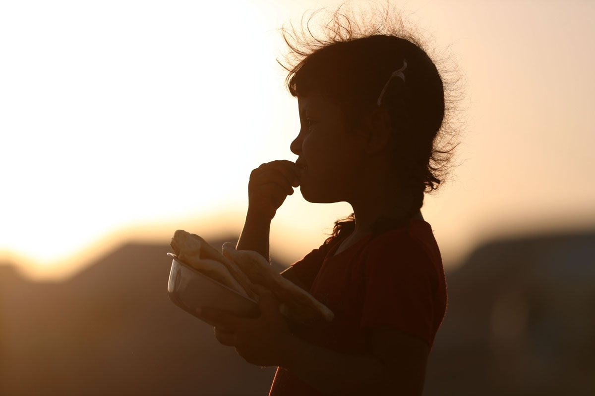 Displaced Iraqis receive aid food during the Muslim holy month of Ramadan at al-Khazir camp for the internally displaced, located between Arbil and Mosul, on June 5,