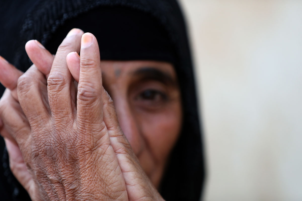 An Iraqi woman sits at the Al-Khazir camp for internally displaced people, located between Arbil and Mosul, on June 6, 2017.