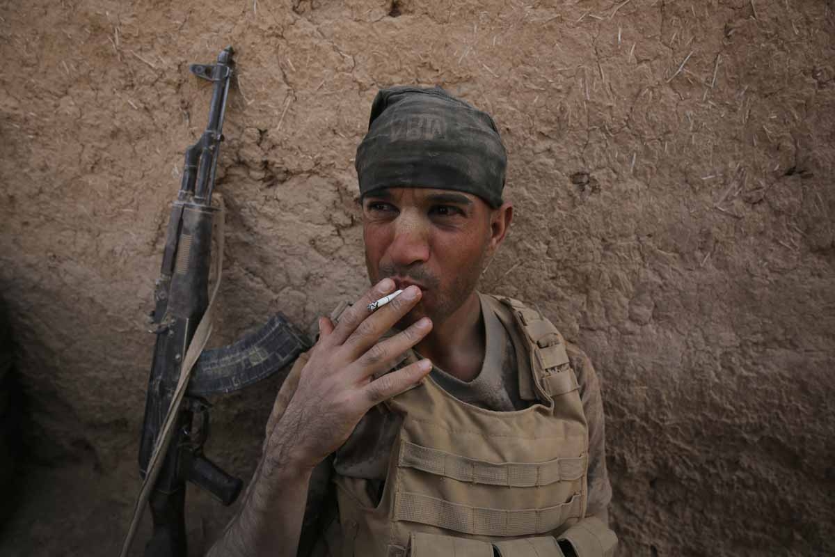 A member of the Iraqi government forces smokes a cigarette as they rest in the village of al-Khuwayn, south of Mosul, after recapturing it from Islamic State (IS) group jihadists on October 23, 2016, in part of an ongoing operation to tighten the noose ar A member of the Iraqi government forces smokes a cigarette as they rest in the village of al-Khuwayn, south of Mosul, after recapturing it from Islamic State (IS) group jihadists on October 23, 2016, in part of an ongoing operation to tighten the noose ar
