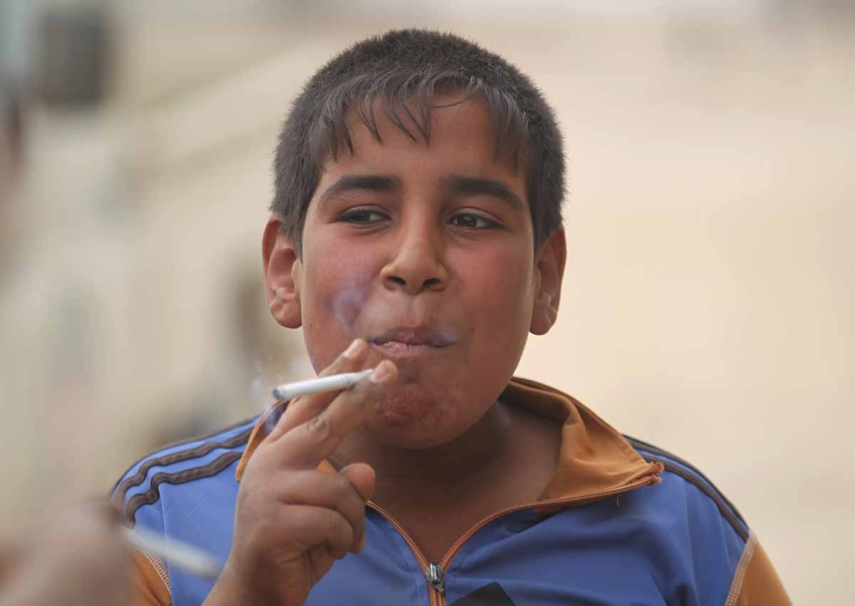 An Iraqi child smokes a cigarette upon the arrival of Iraqi forces in the village of Umm Mahahir, south of Mosul, on October 28, 2016 after troops recaptured it from the Islamic State (IS) group jihadists as part of their operation to retake the main hub An Iraqi child smokes a cigarette upon the arrival of Iraqi forces in the village of Umm Mahahir, south of Mosul, on October 28, 2016 after troops recaptured it from the Islamic State (IS) group jihadists as part of their operation to retake the main hub