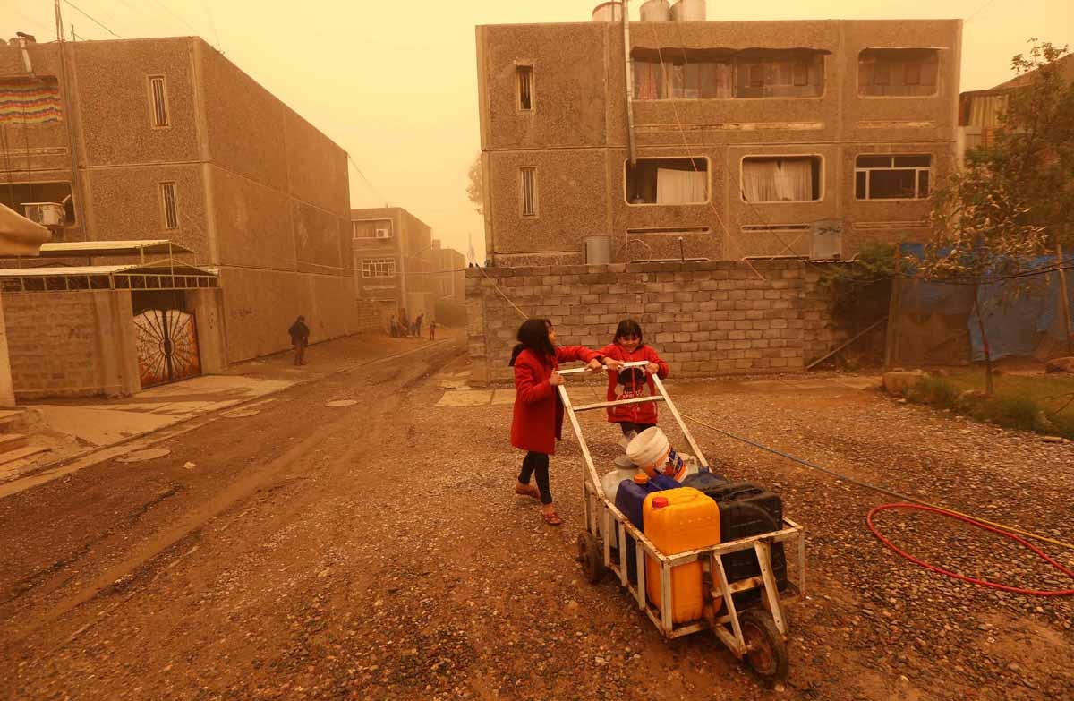 Iraqi girl wait to fill jerricans with water in Mosul's eastern district of Khadraa, on December 2, 2016. Iraqi girl wait to fill jerricans with water in Mosul's eastern district of Khadraa, on December 2, 2016.