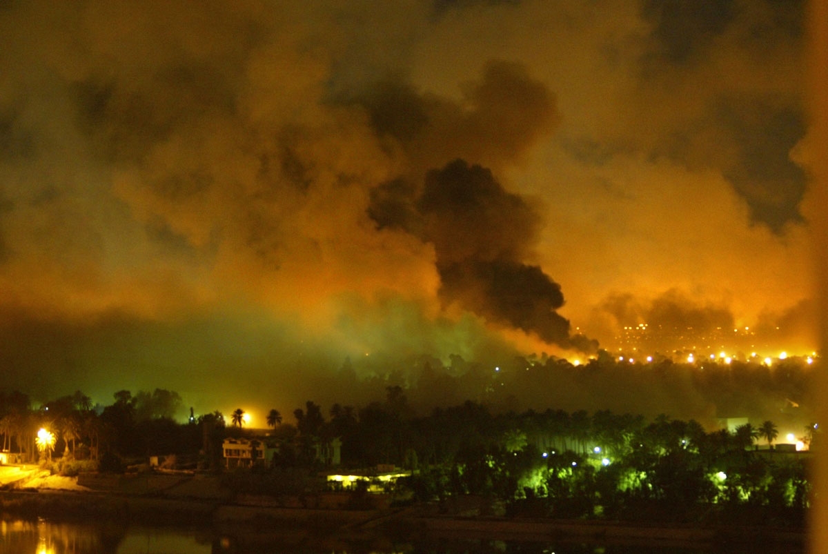 Smoke covers the presidential palace compound in Baghdad 21 March 2003 during a massive US-led air raid on the Iraqi capital. Smoke billowed from a number of targeted sites, including one of President Saddam Hussein's palaces, an AFP correspondent sai