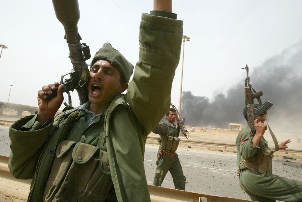 Iraqi Republican Guards shout anti-US slogans as they head to the front south of Baghdad 06 April 2003. US forces closed in on Baghdad from opposite directions, US officials said, as coalition forces prepared to launch a final assault on the battered capi