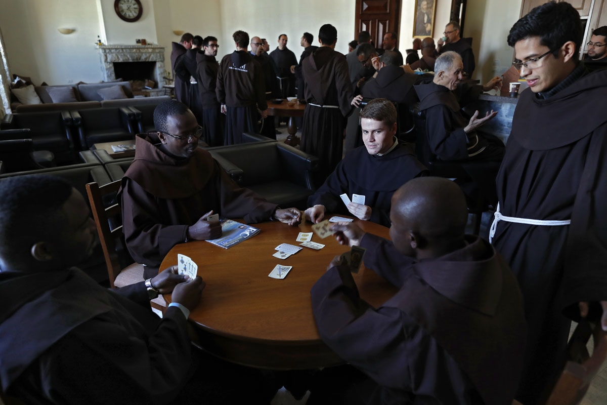 Franciscan friars play cards during a coffee break after lunch at the Saint Saviour Convent, the Franciscan headquarters in the Middle East, in the Old City of Jerusalem, on March 16, 2018.