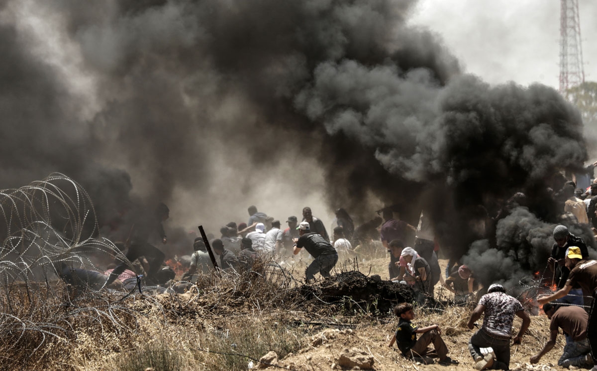 Palestinians clash with with Israeli forces near the border between the Gaza strip and Israel east of Gaza City on May 14, 2018, as Palestinians protest over the inauguration of the US embassy following its controversial move to Jerusalem.