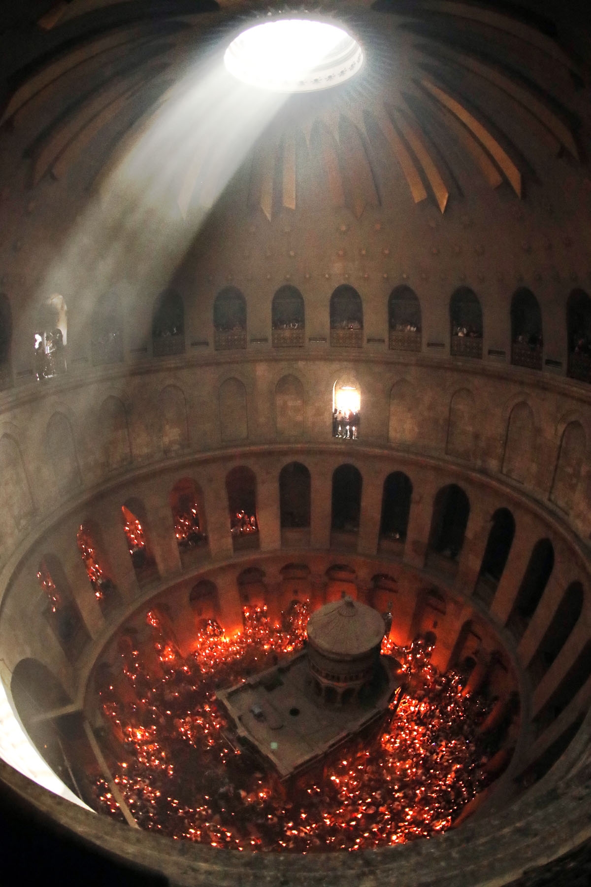 Christian Orthodox worshippers hold up candles lit from the Holy Fire as thousands gather in the Church of the Holy Sepulchre in Jerusalem's Old City, on April 30, 2016, during the Orthodox Easter ceremonies.