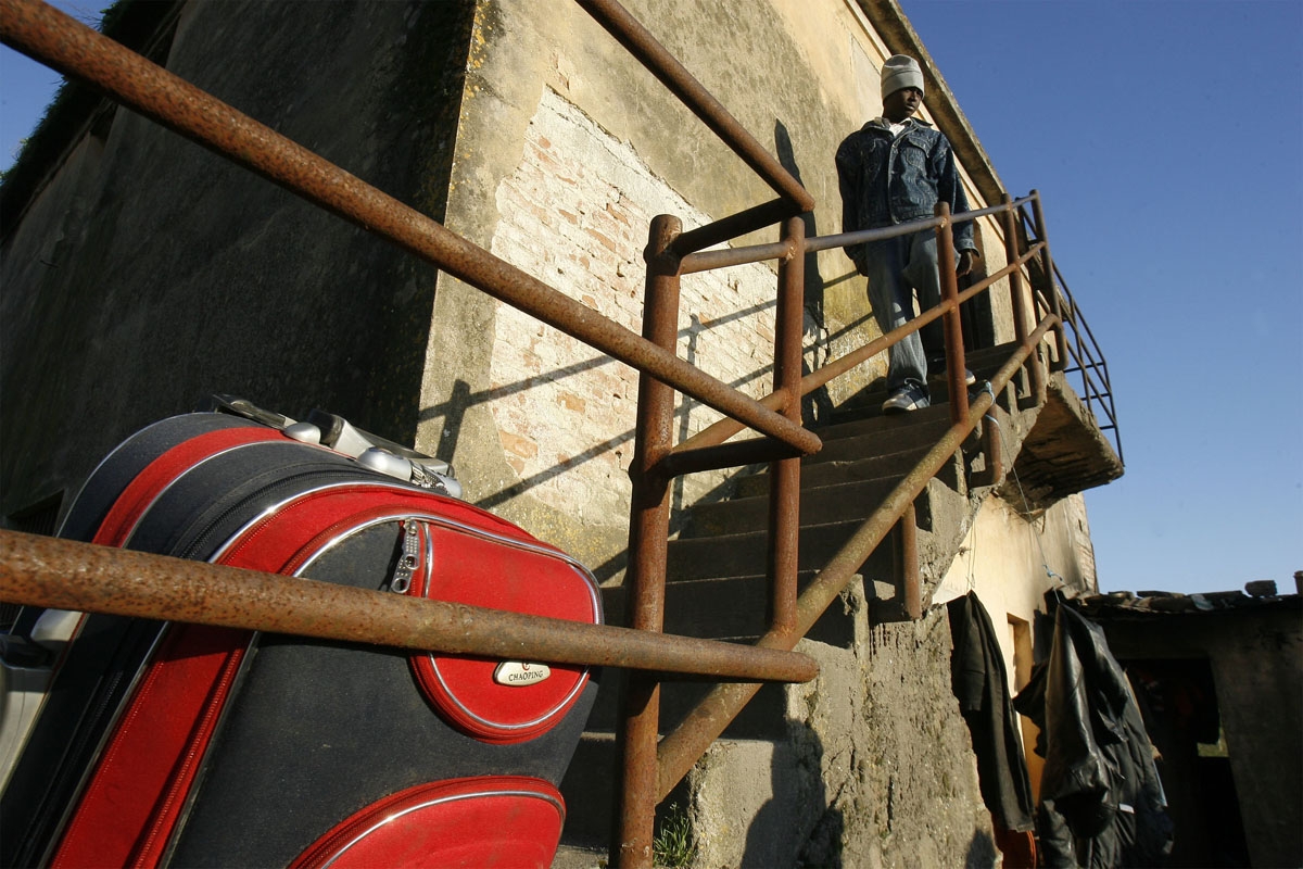 An Immigrant worker prepare to be evacuated from a house where he was living with other migrants in the southern town of Rosarno, on January 9, 2010. Italian authorities sent in extra police and evacuated migrants Saturday from a southern Italian town aft