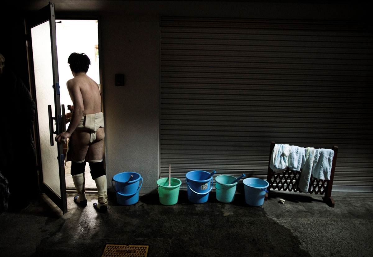 In this picture taken on February 18, 2017, a Japanese man enters a house after the annual Naked Man Festival or 'Hadaka Matsuri' in Okayama, western Japan.