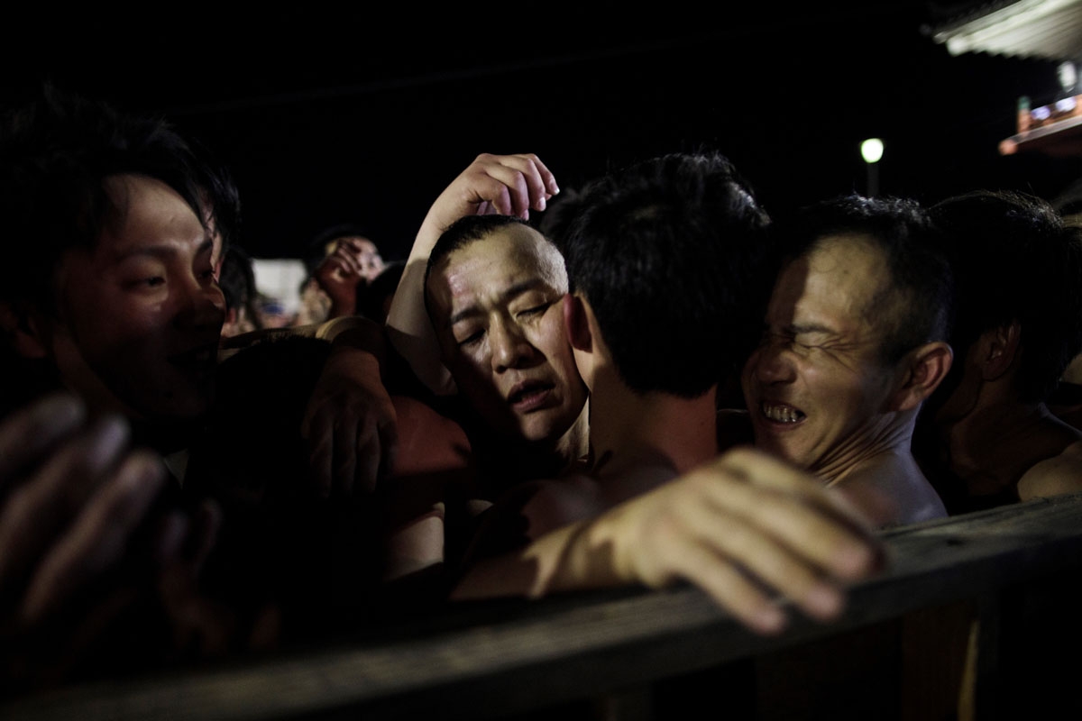 In this picture taken on February 18, 2017, worshippers scuffle to catch the thrown sacred batons during the annual Naked Man Festival or 'Hadaka Matsuri' at Saidaiji Temple in Okayama, western Japan.