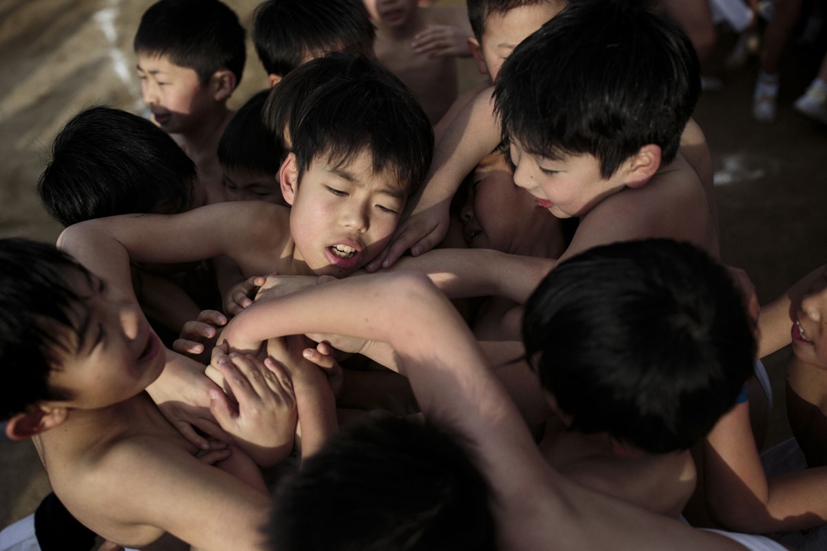 In this picture taken on February 18, 2017, Japanese boys fight to catch sacred batons thrown by priests during the boys' event in the annual Naked Man Festival or 'Hadaka Matsuri' at Saidaiji Temple in Okayama, western Japan.