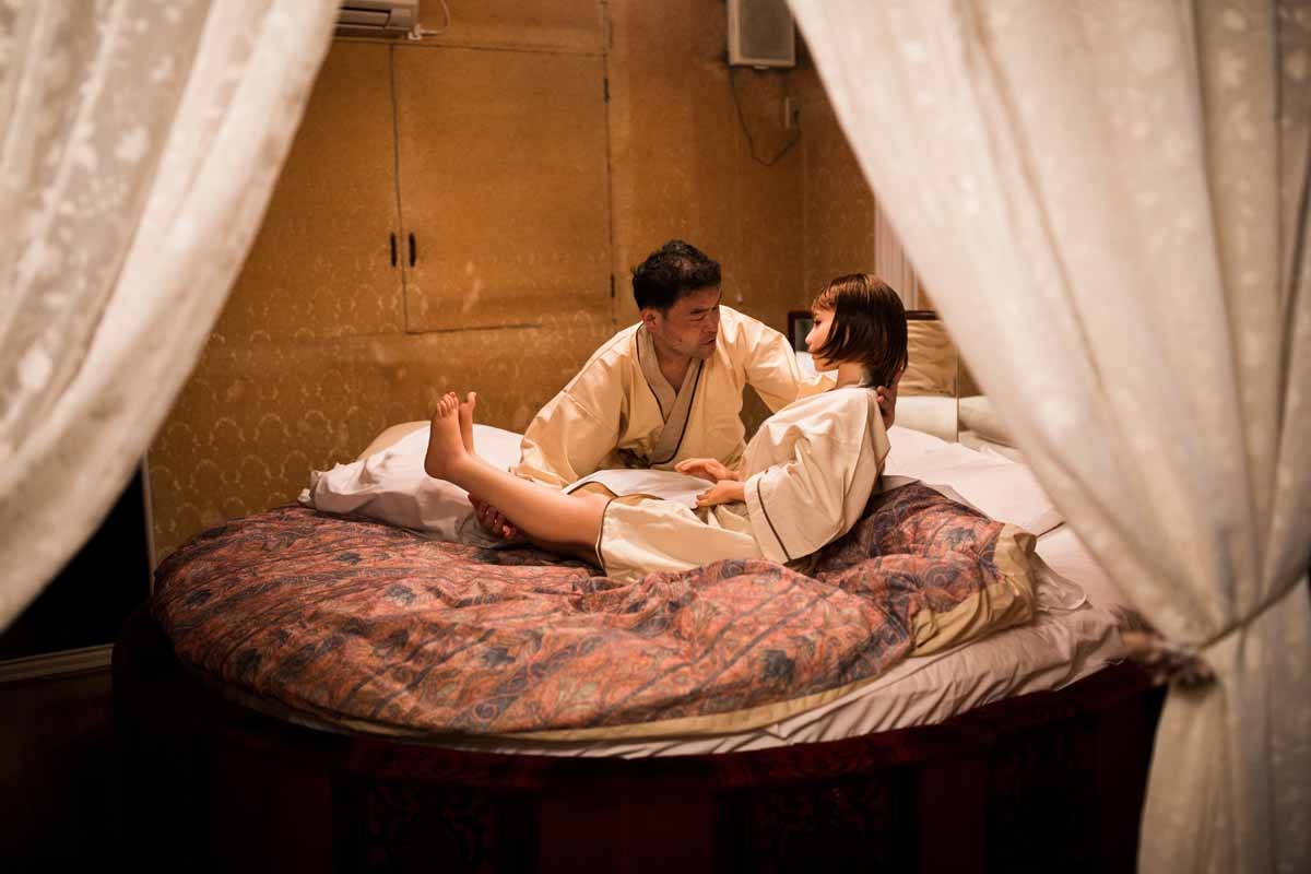 In this picture taken late on June 13, 2017, physiotherapist Masayuki Ozaki puts his silicone sex doll Mayu to bed at a love hotel in Yachimata, Chiba prefecture.