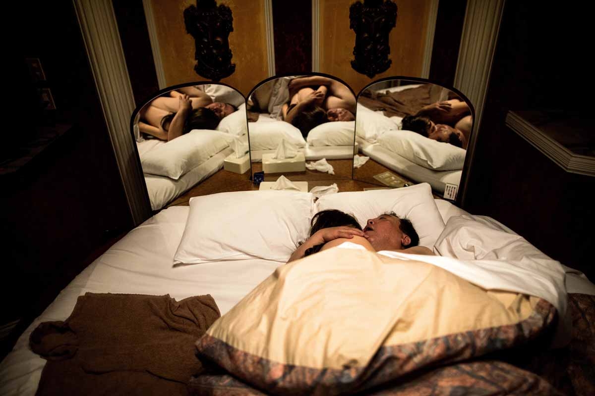 In this picture taken early on June 14, 2017, 62-year-old Senji Nakajima hugs his silicone sex doll Saori while sleeping at a love hotel in Yachimata, Chiba prefecture.