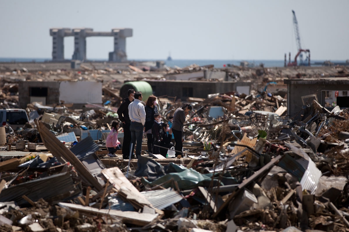 A family prays for the victims at a tsunami devastated area in Rikuzentakata city, Iwate prefecture on April 17, 2011.