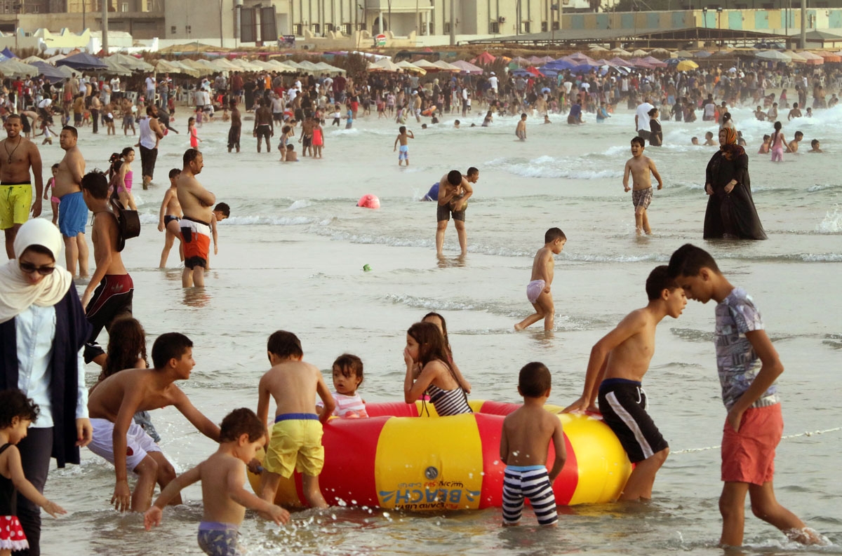 Libyans hang out at the beach in the capital Tripoli on July 14, 2016.