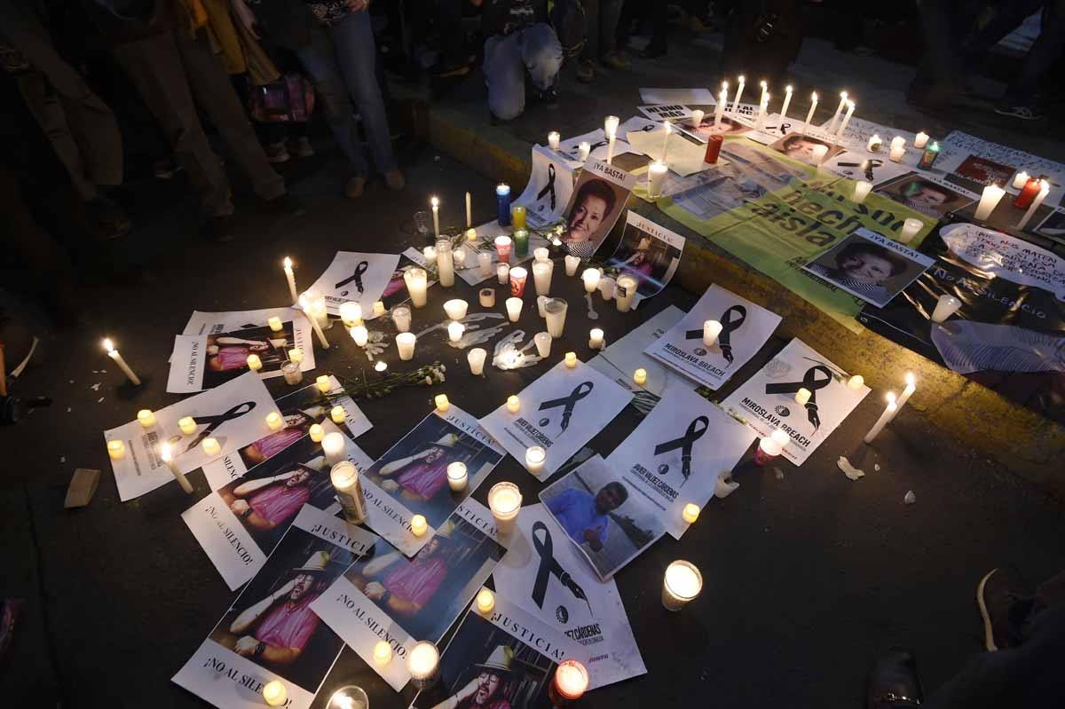 Candles and portraits of slain Mexican journalists are seen during a protest demanding the Mexican government catch the killers of Javier Valdez, the fifth and most high-profile journalist murdered this year in the country's drug-trafficking ganglands, in