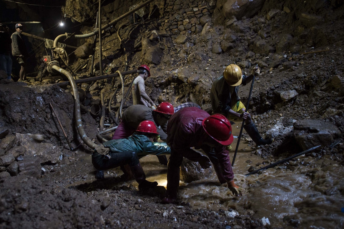 This photo taken on November 24, 2016 shows miners working inside a ruby mine in Mogok, north of Mandalay.