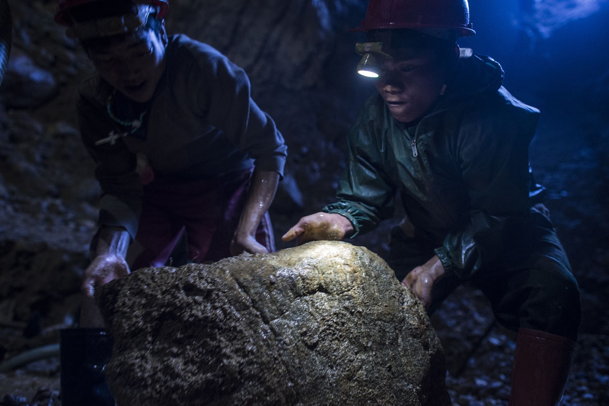This photo taken on November 24, 2016 shows miners working inside a ruby mine in Mogok, north of Mandalay.