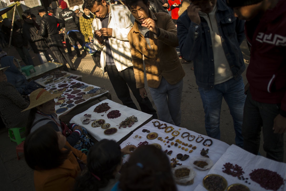 This photo taken on November 25, 2016 shows people selling gems in the gems market in Mogok, north of Mandalay.
