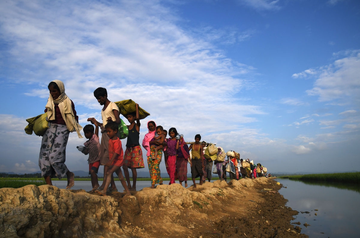 Rohingya Muslim refugees who were stranded after leaving Myanmar walk towards the Balukhali refugee camp after crossing the border in Bangladesh's Ukhia district on November 2, 2017.