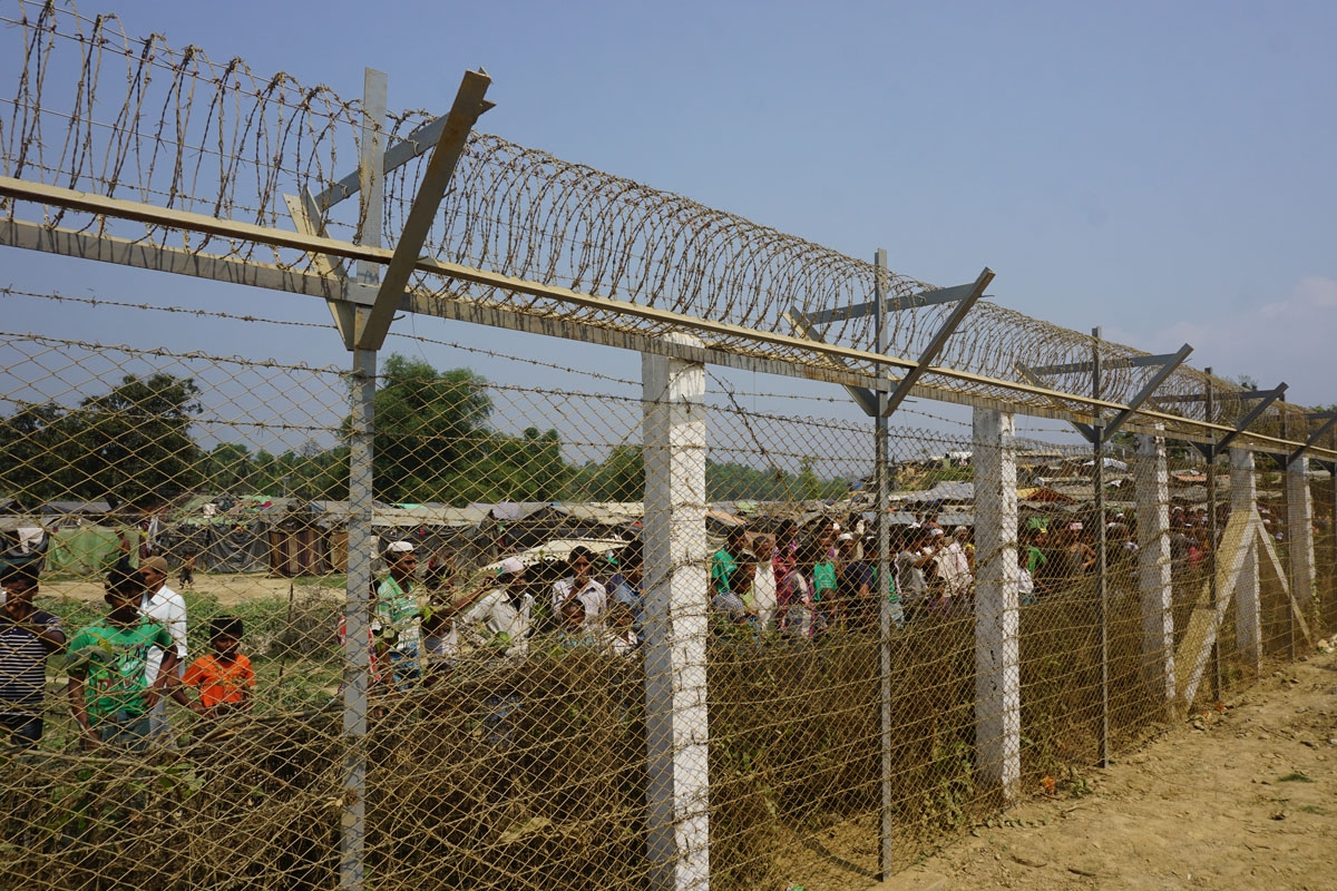 Minority Rohingya Muslims gather behind Myanmar's border lined with barbed wire fences in Maungdaw district, located in Rakhine State bounded by Bangladesh on March 18, 2018.